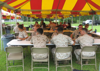 marines sitting at table eating fish fry